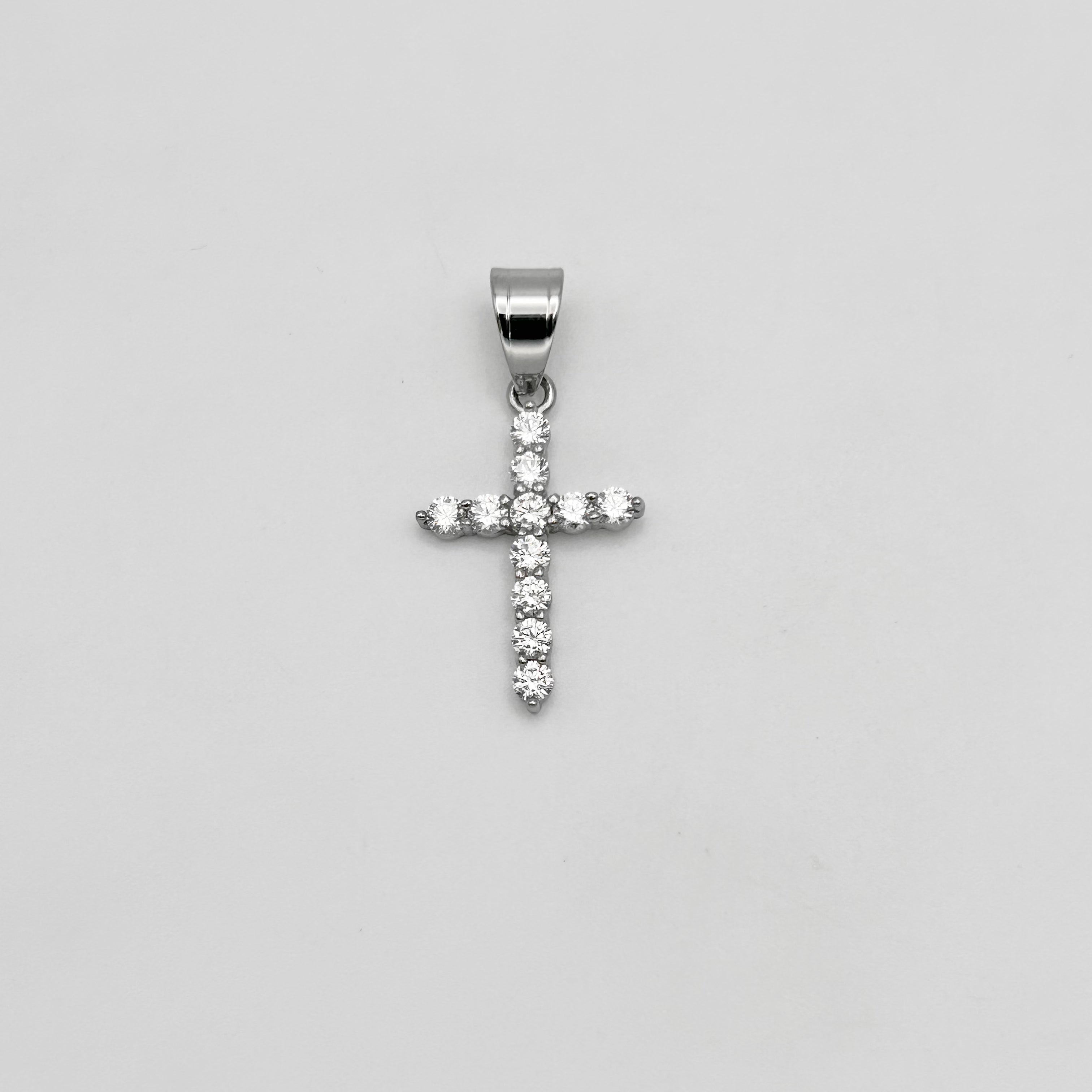 Silver color cross pendant with clear stones